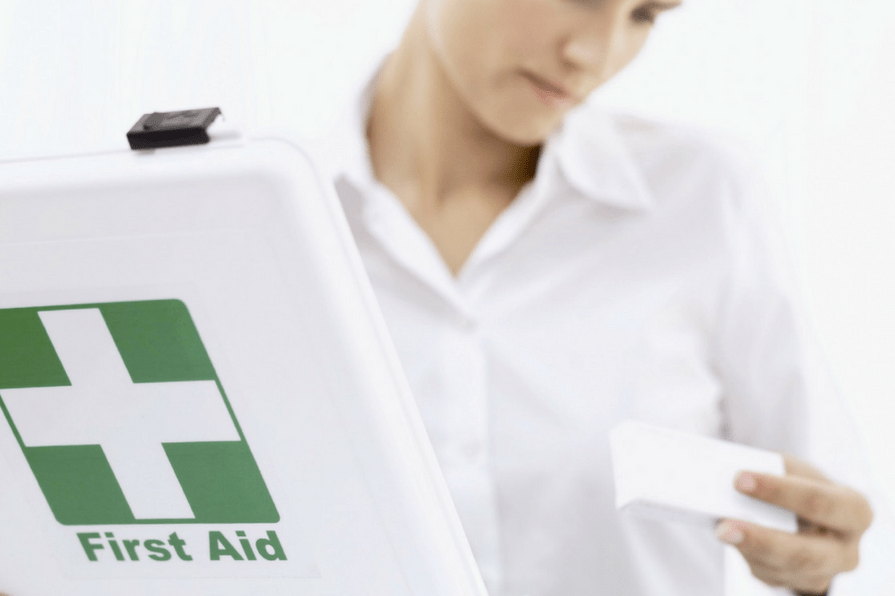 Woman restocking a first aid kit